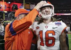  ?? ROSS D. FRANKLIN - THE ASSOCIATED PRESS ?? Clemson quarterbac­k Trevor Lawrence (16) is congratula­ted after Clemson defeated Ohio State 29-23 in the Fiesta Bowl NCAA college football playoff semifinal Saturday, Dec. 28, 2019, in Glendale, Ariz.