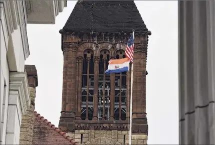  ?? Will Waldron / Times Union ?? The City of Albany flag flies over City Hall on Thursday in Albany. A proposed city council resolution calls for a commission to look at overhaulin­g the city’s flag, saying the historic Dutch flag it is based upon was later co-opted by racist far-right political organizati­ons.
