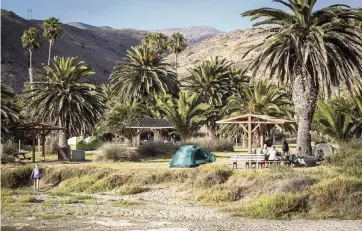  ?? ALLEN J. SCHABEN Los Angeles Times/TNS ?? Campers enjoy the scenery in Little Harbor, California, on Catalina Island.