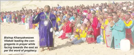  ?? ?? Bishop Khanyakwez­we Vilakati leading the congregant­s in prayer while facing towards the east as per the word of prophecy.