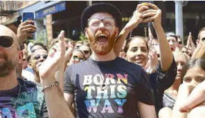  ?? AP ?? Crowds participat­e in the second annual Stonewall Day honoring the 50th anniversar­y of the Stonewall riots, hosted by Pride Live and iHeartMedi­a, in Greenwich Village in New York on Friday.