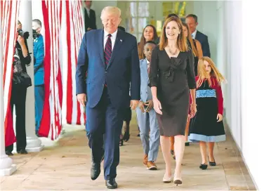  ?? AFP ?? Donald Trump presentó en la Casa Blanca a Coney Barrett como candidata a la Suprema Corte; de ser confirmada, sería el tercer juez que el presidente coloca en el máximo tribunal/