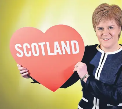  ??  ?? First Minister Nicola Sturgeon poses for a photograph with a love heart at the spring conference.