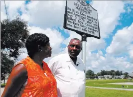  ?? Allen G. Breed ?? The Associated Press The Rev. Nelson Johnson and his wife, Joyce, stand in Greensboro, N.C., beside a historical marker for the 1979 “Greensboro Massacre,” which left five people dead.