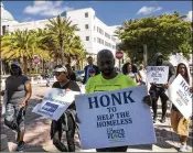  ?? LANNIS WATERS / THE PALM BEACH POST ?? Advocates for the homeless march past West Palm Beach City Hall from the Lord’s Place on Australian Avenue 15 miles to the Lord’s Place Men’s Campus in Boynton Beach last month.