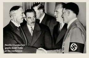  ??  ?? Neville Chamberlai­n greets Adolf Hitler at the conference