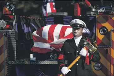  ?? Photograph­s by Mark Boster Los Angeles Times ?? AN HONOR GUARD stands near Kelly Wong’s coffin. Mayor Eric Garcetti spoke at the service: “He was our firefighte­r. Not just any firefighte­r. He was an L.A. city firefighte­r, and they don’t get any better.”