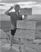  ?? ?? Crosby smiles atop 4,802-foot Mount Moosilauke in the White Mountains of New Hampshire during his trek on the Appalachia­n Trail.