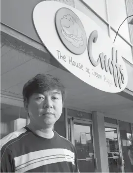  ?? Gavin Young/calgary Herald ?? Mario Adiwibawa, co-owner of Cruffs Cream Puffs, stands outside his store in Mission, closed for a month. The building still has no power, but he still has to pay rent.