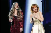  ?? [PHOTO BY CHRIS PIZZELLO, INVISION/AP] ?? Lauren Daigle, left, and Reba McEntire perform “Back to God” at the 52nd annual Academy of Country Music Awards at the T-Mobile Arena on April 2, 2017, in Las Vegas.