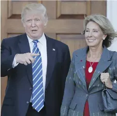  ?? CAROLYN KASTER / THE ASSOCIATED PRESS ?? Donald Trump and Betsy DeVos, who Trump has chosen as education secretary in his administra­tion.