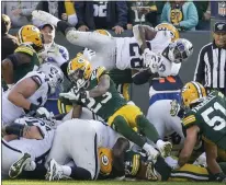  ?? MIKE ROEMER — THE ASSOCIATED PRESS ?? Talented Oakland Raiders rookie Josh Jacobs, who ran for 124 yards in Sunday’s loss to the Green Bay Packers, is stopped just short of the goal line on a fourth-down run in the fourth quarter.