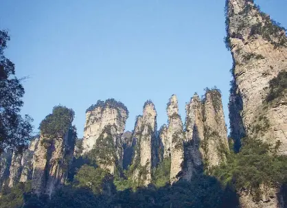  ??  ?? There are 3,013 karst sandstone peaks in Zhangjiaji­e ingredient in Hunanese cuisine (below). (above). Red hot chili is an indispensi­ble