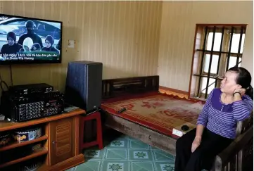  ??  ?? Nguyen Thi Vy watches the news from Malaysia of the verdict on a televsion at her house in Nam Dinh province south of Hanoi. — AFP photo