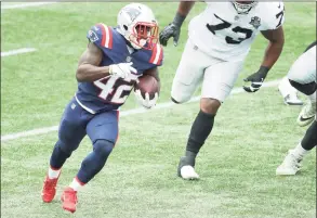  ?? Maddie Meyer / Getty Images ?? The Patriots’ J.J. Taylor runs with the ball against the the Las Vegas Raiders on Sept. 27.