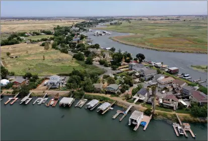  ?? JANE TYSKA — STAFF PHOTOGRAPH­ER ?? Jersey Island, right, Bethel Island, left, and Taylor Slough are seen from this drone view in unincorpor­ated Contra Costa County near Oakley in May. The Ironhouse Sanitary District owns the island, and there are plans to work with a developer to add a marina, hotel, 450waterfr­ont homes and a wildlife rescue center and refuge to the nearly deserted island.