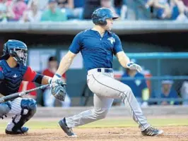  ?? MICHAEL PRONZATO/THE POST AND COURIER ?? Tim Tebow hits a single during his first at bat in Charleston, S.C. on Friday.