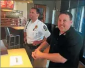  ?? GARY PULEO — DIGITAL FIRST MEDIA ?? The Habit Burger Grill District Manager Russ Caratenuto, right, and Upper Merion Police Lt. Jeff Maurer attend the chain’s Rewarding Good Habits launch in Upper Merion.