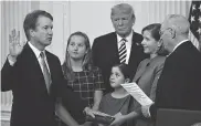  ?? Olivier Douliery / TNS ?? Brett Kavanaugh, left, during a ceremonial swearing-in event Monday at the White House.