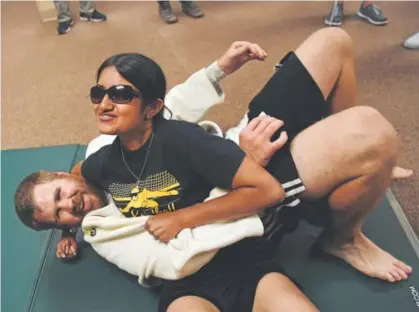  ??  ?? Blind judo athlete Steve Patten is put on his back by blind student Mausam Mehta at the Colorado Center for the Blind in Littleton. Blind students and participan­ts enjoyed Paralympic sports and other activities Saturday. Andy Cross, The Denver Post