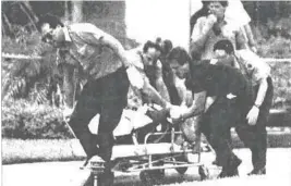  ?? STAFF FILE PHOTO ?? Paramedics take Marlene Warren to an ambulance on Saturday, May 26, 1990, after she was shot in front of her home in Wellington.