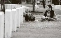  ?? Kin Man Hui / Staff photograph­er ?? Ret. Army Spc. Irene Brown sits beside the grave site of her husband, Army Spc. Losse Keone Brown, on Monday.