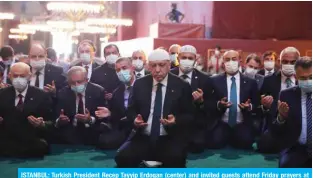  ?? — AFP ?? ISTANBUL: Turkish President Recep Tayyip Erdogan (center) and invited guests attend Friday prayers at the Hagia Sophia during its official opening ceremony.