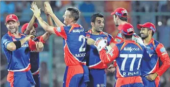  ??  ?? Delhi Daredevils cricketers celebrates the wicket of Hashim Amla at Feroz Shah Kotla Stadium in New Delhi on Saturday.