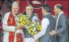  ?? WASEEM ANDRABI/HT ?? National Conference working president Omar Abdullah greets his father Farooq Abdullah (left) who was reelected as the party’s president in Srinagar on Sunday.