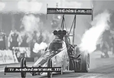  ?? Thomas B. Shea ?? Top Fuel driver Brittany Force comes off the line during second-round qualifying in the NHRA SpringNati­onals at Royal Purple Raceway in Baytown. She is seventh after her 3.761-second run at 298.54 mph.