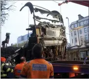  ?? BRIAN LAWLESS — PA VIA AP ?? A burned out bus is removed from O’Connell Street in the aftermath of violent scenes in the city centre on Thursday evening, in Dublin, Nov. 24.