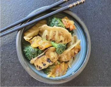  ?? Photo by Ari LeVaux. ?? Ari LeVaux just went there: Pot stickers with broccoli and tomato stir-fry.