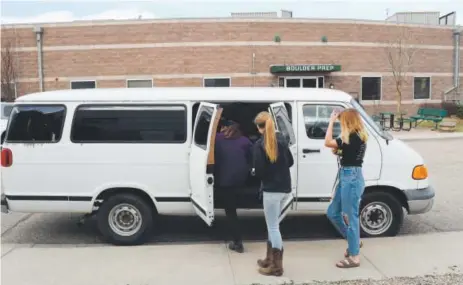  ?? RJ Sangosti, The Denver Post ?? Students from Boulder Preparator­y High School load into a van to visit a nearby horse ranch for a biology lesson.