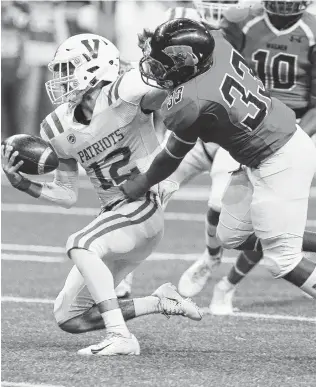  ?? Photos by Kin Man Hui / Staff photograph­er ?? Michael Turbin brings down Mission Veterans Memorial quarterbac­k Landry Gilpin for one of Wagner’s six sacks Saturday. The T-Birds also pressured Gilpin into three intercepti­ons.