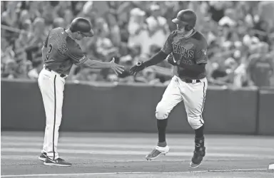  ?? AP ?? The Diamondbac­ks’ Wilmer Flores, right, rounds third base and past third-base coach Tony Perezchica after hitting a home run against the Giants in the fifth inning on Sunday at Chase Field in Phoenix.