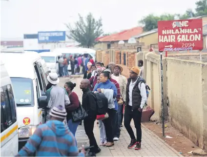  ?? Picture: Nigel Sibanda ?? SLOW START TO THE DAY. Commuters line up at a minibus taxi rank in Soweto yesterday on the first day of the national bus strike which affected Rea Vaya Services.