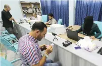  ?? Reuters ?? People go through a registrati­on process for new identifica­tion cards at the Al Bab city council offices in Aleppo. —