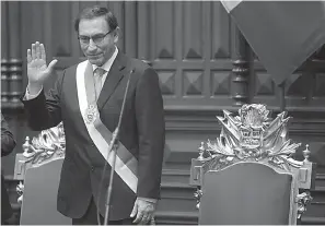  ?? AP Photo/Martin Mejia ?? ■ Peru’s President Martin Vizcarra waves after he was sworn in on Friday in Lima, Peru. He replaces Pedro Pablo Kuczynski, who has resigned over corruption allegation­s. Vizcarra has scarce experience governing but is known as a consensus builder who...