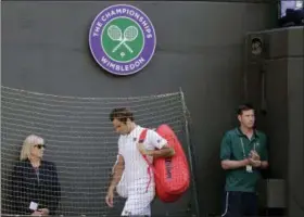  ?? BEN CURTIS — THE ASSOCIATED PRESS ?? Switzerlan­d’s Roger Federer leaves the court after losing his men’s quarterfin­als match against Kevin Anderson of South Africa, at the Wimbledon Tennis Championsh­ips, in London Wednesday.