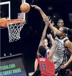  ?? Kathy Willens / Associated Press ?? The Nets’ Kevin Durant dunks over Thomas Bryant on Sunday. Durant finished with 28 points, 11 rebounds and seven assists.