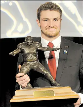  ?? NWA Democrat-Gazette/DAVID GOTTSCHALK ?? Luke Falk, quarterbac­k for Washington State University, received the 2017 Burlsworth Trophy on Monday at the Northwest Arkansas Convention Center in Springdale. The award is named after Brandon Burlsworth, a former walk-on for the Arkansas Razorbacks.