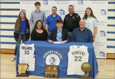  ?? Contribute­d Photo ?? PC standout signs: Parkers Chapel's Nate Garrett-Evans is pictured after signing with Crowley's Ridge on Wednesday. Garrett-Evans averaged 17 points per game for the Trojans, who advanced to the 2A state semifinals.