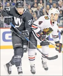  ?? Anthony J. Causi ?? ICY HIT: Anders Lee throws a hard check at the Blackhawks’ Niklas Hjalmarsso­n during the Islanders’ 5-4 loss Thursday night at Barclays Center.