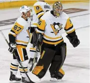  ?? AP ?? Pittsburgh Penguins center Sidney Crosby and goaltender Tristan Jarry skate off the ice after losing to the New York Rangers in overtime of Game 7 Sunday.