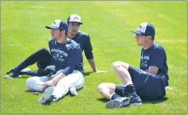  ?? PHOTO BY BERT HINDMAN ?? Pitchers David Russo, left, Cody Hebner and Pat Misch for the Southern Maryland Blue Crabs sit on the field during a recent spring training session. The Blue Crabs open the season on Thursday night versus the Long Island Ducks at Regency Furniture...