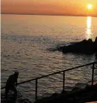  ??  ?? A swimmer at sunrise at the Forty Foot in Sandycove, Dublin