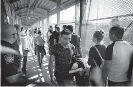  ?? EMILIO ESPEJEL/AP 2019 ?? Migrants return to Mexico as others line up to request asylum in the U.S. at the bridge in Matamoros, Mexico, that crosses into Brownsvill­e, Texas.