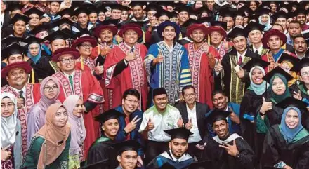 ?? BERNAMA PIC ?? Youth and Sports Minister Syed Saddiq Syed Abdul Rahman with Technical and Vocational Education and Training graduates at the fifth Malaysian Youth Council convocatio­n ceremony in Bangi yesterday.