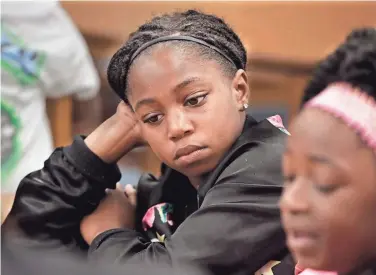  ?? RICK WOOD / MILWAUKEE JOURNAL SENTINEL ?? Samuel Clemens Elementary School third-grader Nevaeha Ware, 9, was despondent as she talked about her brother, Qwaishaun D. Henning, 19, who was shot to death May 1. For more photos, go to jsonline.com/news.