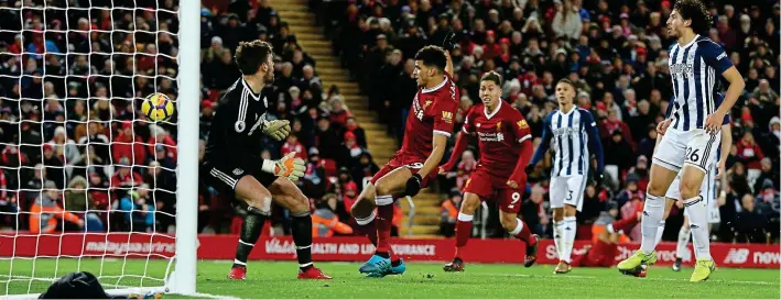  ?? PA WIRE ?? So close and yet so far: Dominic Solanke scores for Liverpool with just minutes left as West Brom defenders look on — but his goal is disallowed for handball